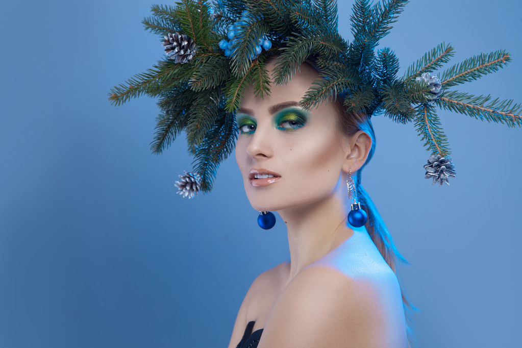 Ładne kobiety poważne z Boże Narodzenie drzewo wieniec na głowę patrząc na przyszedł - Zdjęcie, obraz