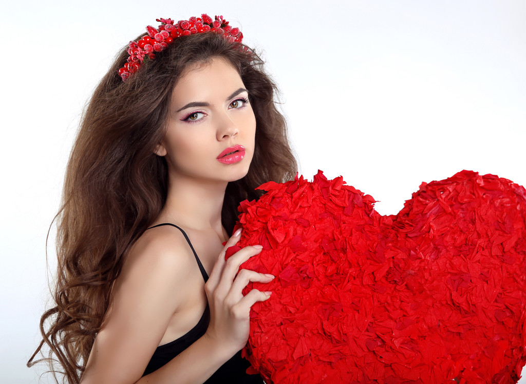 Beautiful brunette girl with red heart gift for Valentines Day.  - Photo, Image