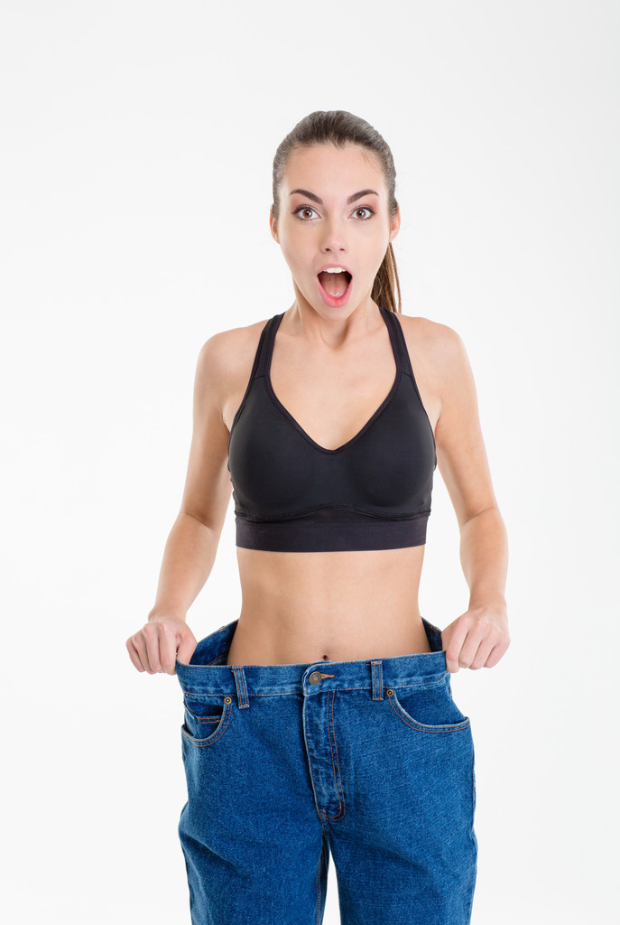 Menina fitness magro chocado em jeans que se tornou muito grande
  - Foto, Imagem