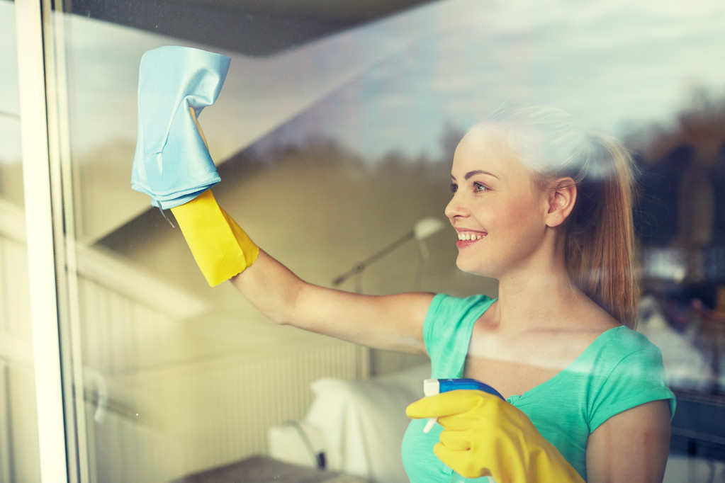 femme heureuse en gants nettoyage fenêtre avec chiffon
 - Photo, image