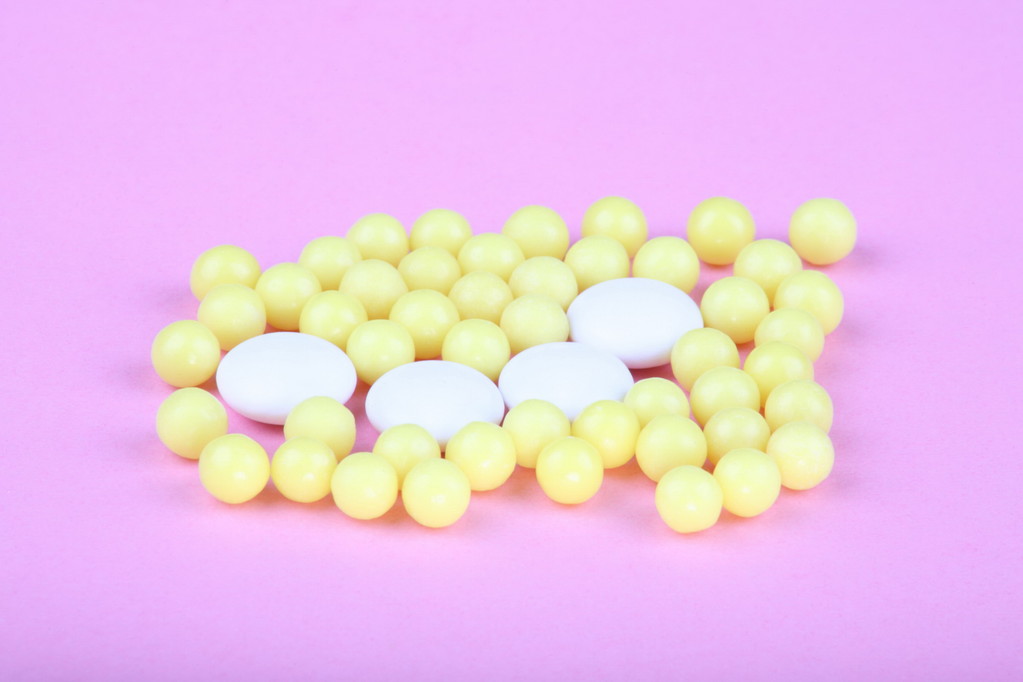 yellow vitamins on pink background - Photo, Image