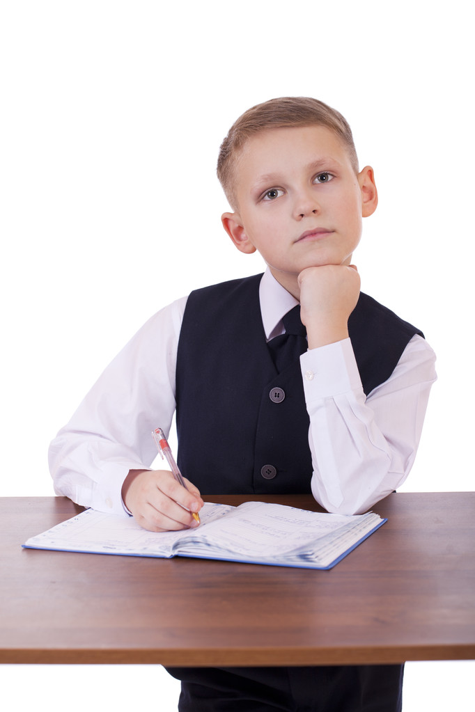 Caucasian school boy at his desk on white background with copy s - Photo, Image