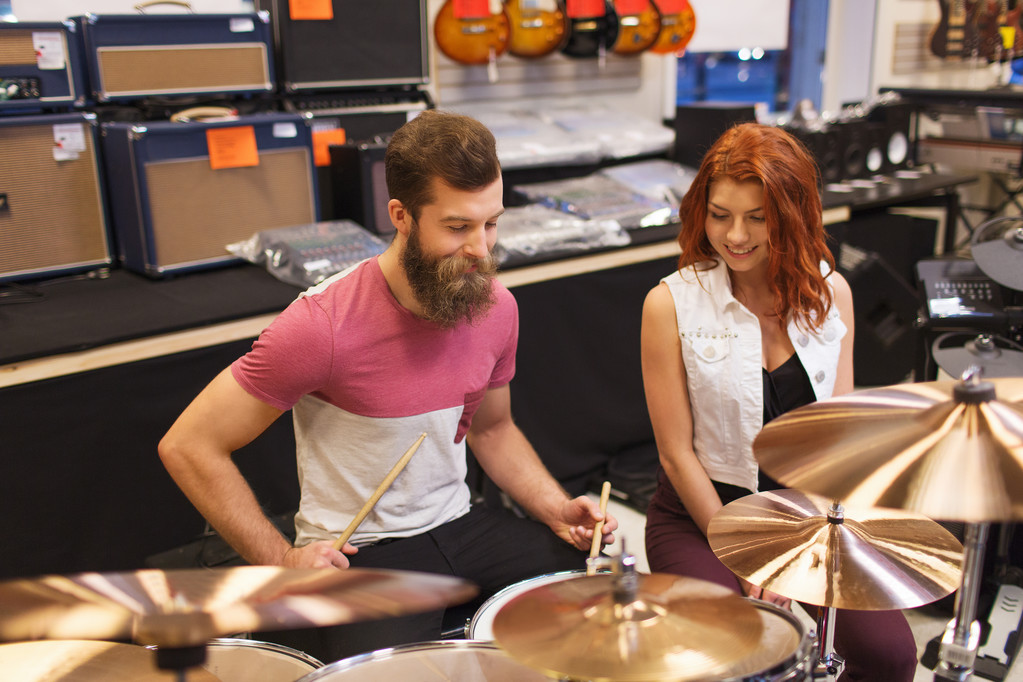 felice uomo e donna che suonano piatti al negozio di musica
 - Foto, immagini