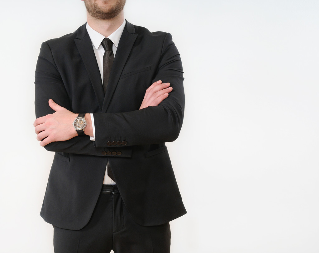 business man body side folded his arms in black suit on white ba - Fotó, kép