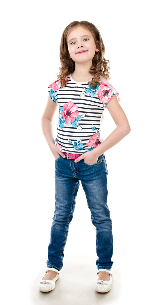 Мила усміхнена маленька дівчинка в джинсах ізольована
  - Фото, зображення