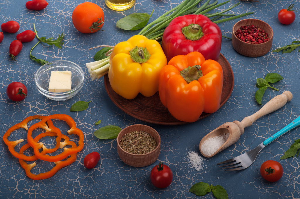 Vegetarian concept. Multi-colored pepper on a blue background, a number of spices and herbs. - Fotoğraf, Görsel