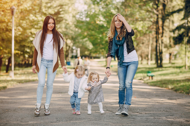 young family walking in the park - Фото, зображення