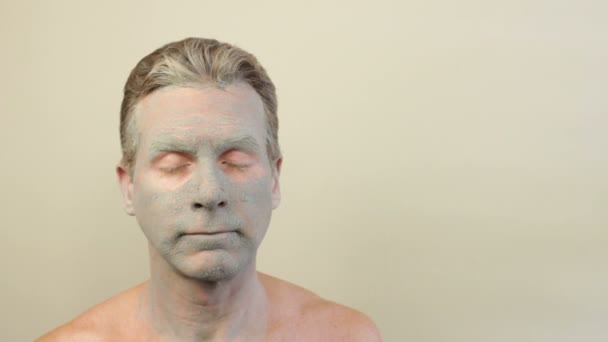 Mężczyzna ubrany w zielony maskę gliny - Materiał filmowy, wideo