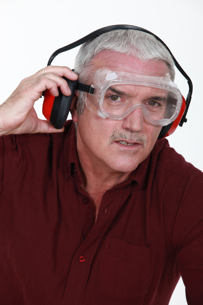 Senior man with goggles and protective headphones - Фото, изображение