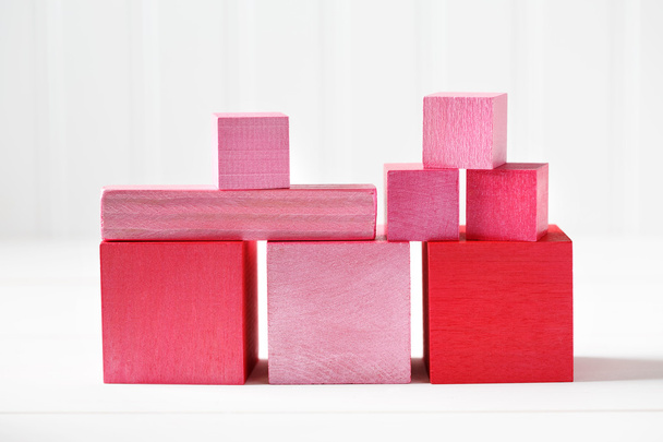 Colorful red and pink wooden blocks - Foto, afbeelding