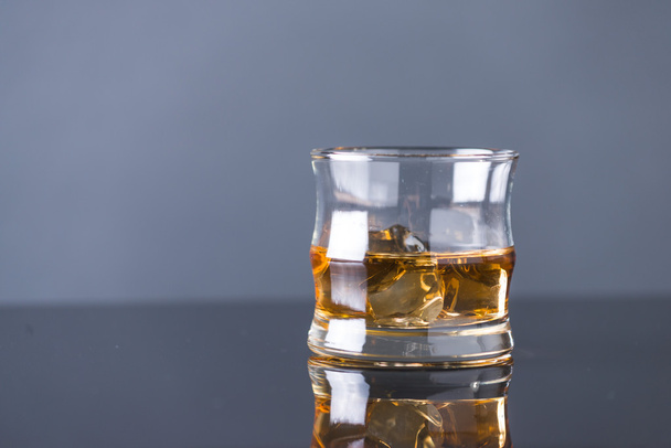 whiskey on the rocks on glass table - Zdjęcie, obraz