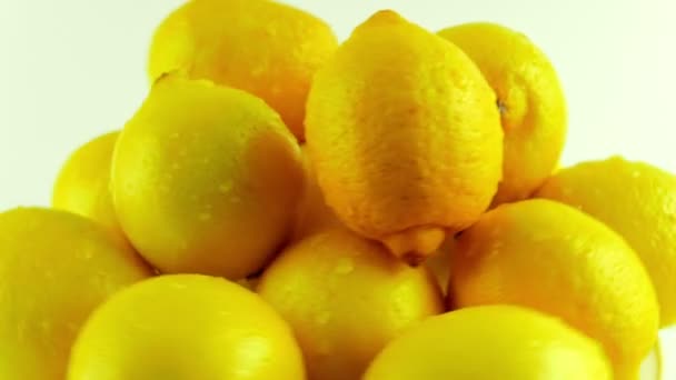 A Group of Fresh Lemons Rotating Against a White Background - Кадри, відео
