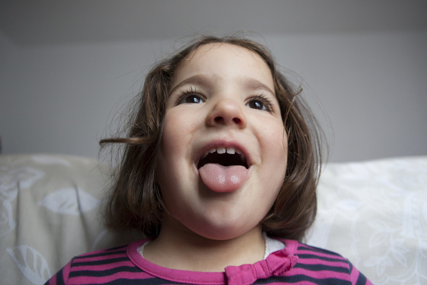 Joker three years old little girl, with tongue out - Photo, Image