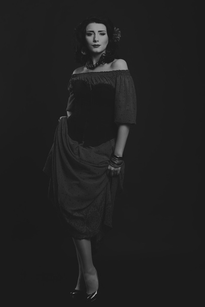 Elegant girl in a black dress. beautiful actress in emotional pose. - Foto, afbeelding