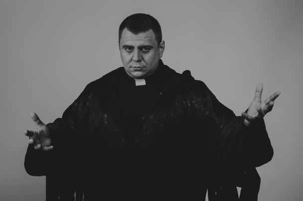 The professional game stage actor at the camera in the image of the priest. Theatrical productions. Professional makeup and costume designer. Photo for religious and cultural magazines and websites. - Фото, зображення