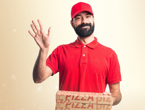 Pizza delivery man saluting - Foto, Imagen