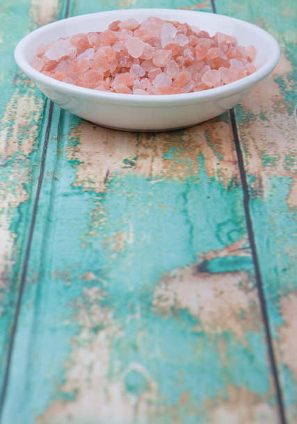 Himalayan rock salt in white bowl over wooden background - Photo, Image