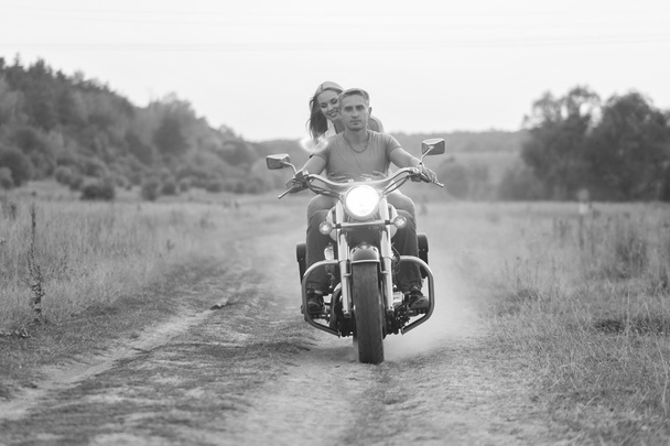 Happy couple traveling on a motorcycle. Extraordinary lifestyle. - Photo, Image