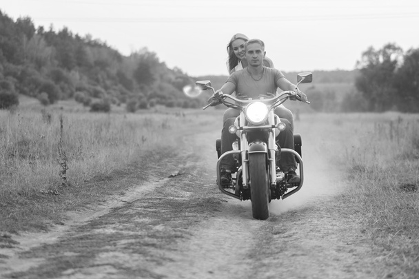 Happy couple traveling on a motorcycle. Extraordinary lifestyle. - Photo, Image
