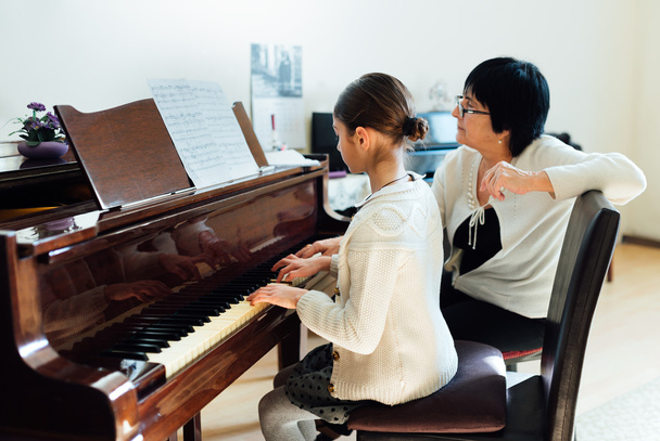  music teacher with the pupil at  lesson piano - Valokuva, kuva