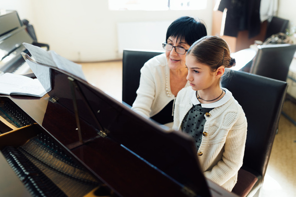  music teacher with the pupil at  lesson piano - Φωτογραφία, εικόνα