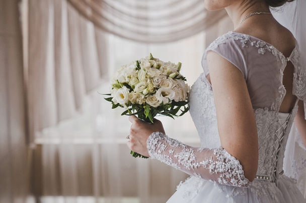 A bouquet of white roses in hands of bride 5168. - Photo, image