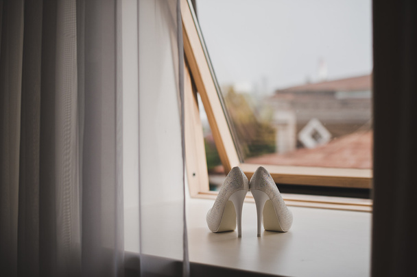 Beautiful white shoes on the windowsill 5178 - Фото, зображення