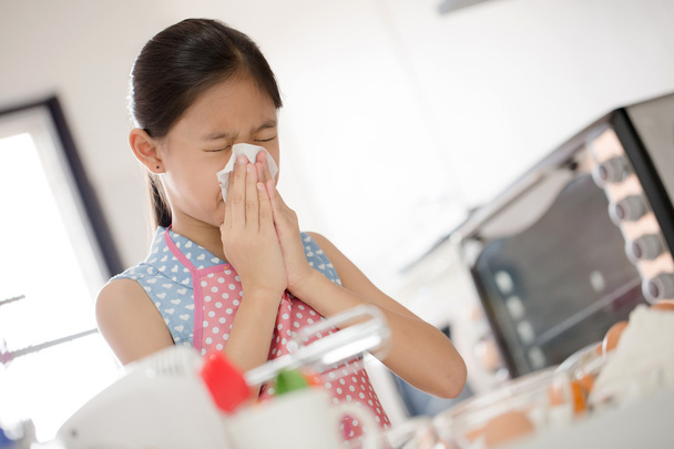 Girl is blowing her nose, allergic to flour - Photo, Image