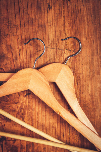 Two retro cloth hangers on rustic wooden background, top view - Фото, зображення