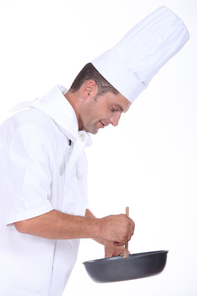 A chef preparing a meal - Foto, afbeelding