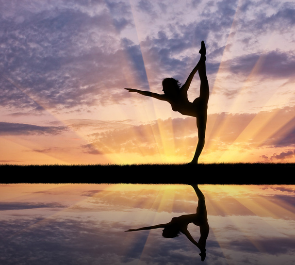 Silhouette of a girl practicing yoga - Фото, зображення