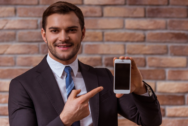 Attractive businessman with gadget - Photo, image
