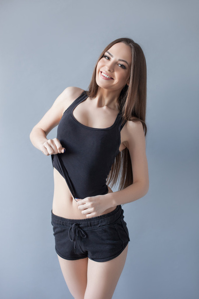 Cute fit girl is showing her perfect body - Fotoğraf, Görsel