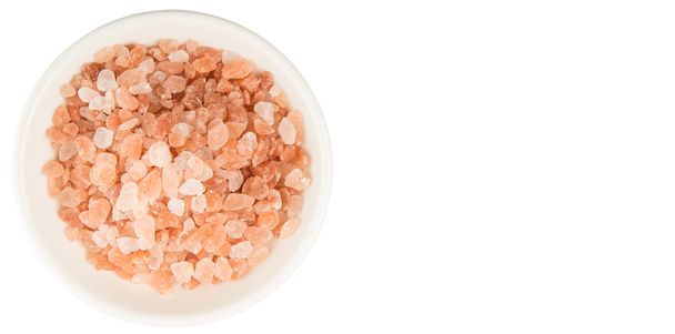Himalayan rock salt in white bowl over white background - Photo, Image