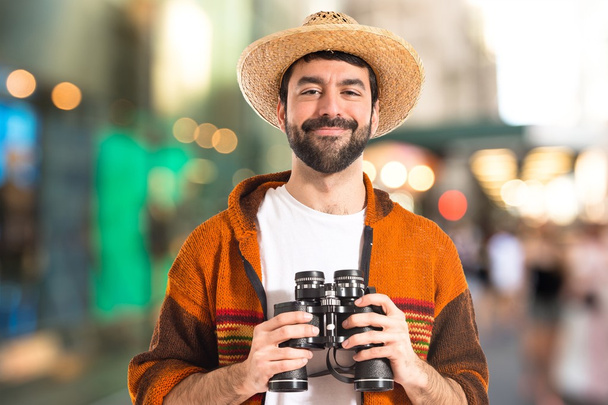 Tourist with binoculars over white background   - Photo, image
