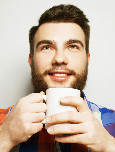 young bearded man with a cup of coffee - Foto, Bild