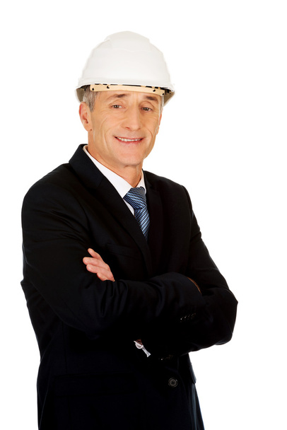Smiling businessman with hard hat - Foto, afbeelding