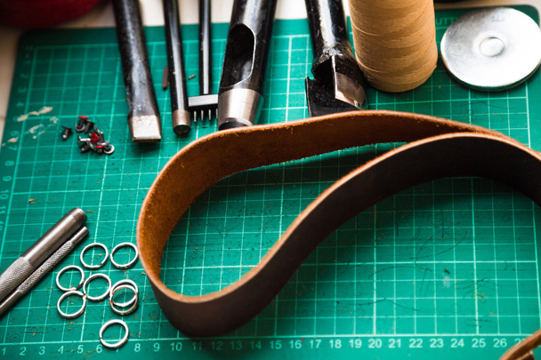Leather crafting tools on work table.  - Photo, Image