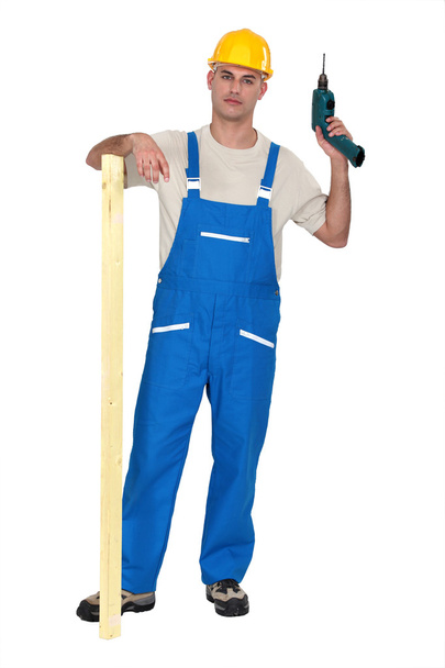 A male carpenter with a drill. - Φωτογραφία, εικόνα