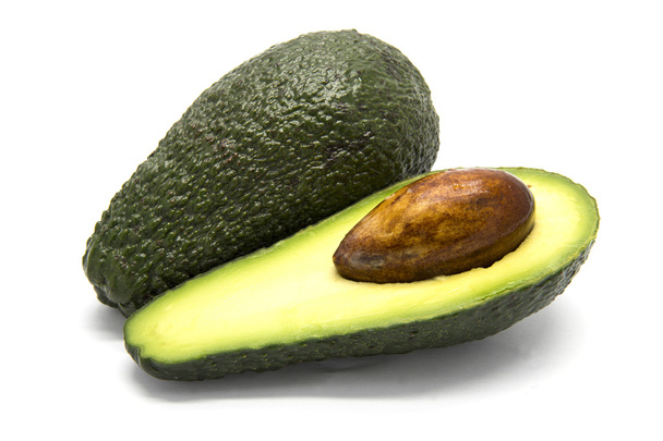 One whole and one sliced avocado - Photo, Image