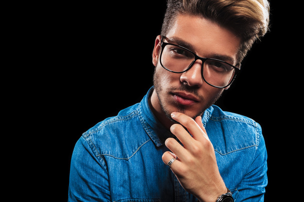 young man wearing glasses while thinking and posing  - Фото, зображення