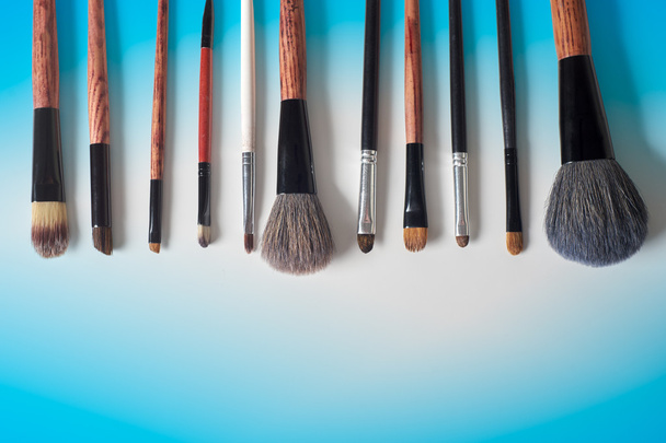 makeup brush and cosmetics, on a color background - Valokuva, kuva