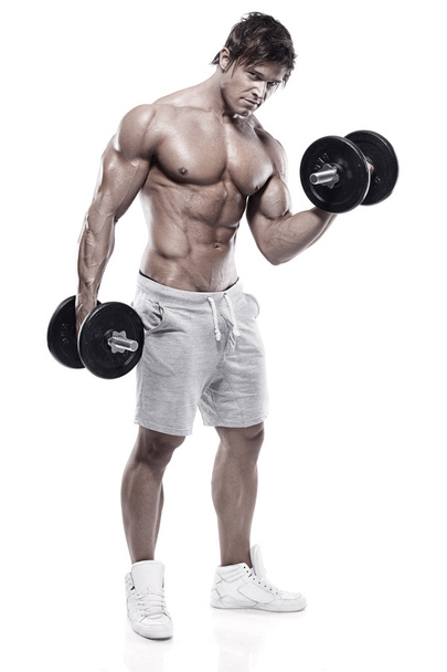 Muscular bodybuilder guy doing exercises with dumbbells - Foto, Bild