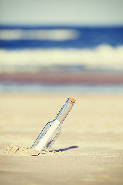 Mensaje vintage tonificado en una botella en la playa, profundidad superficial de fie
 - Foto, Imagen