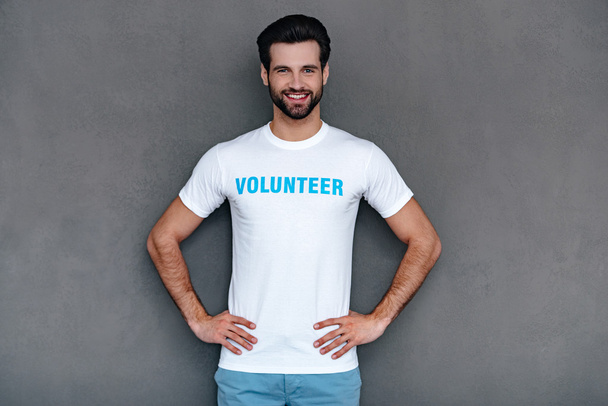 Confident young man in volunteer t-shirt - Foto, immagini