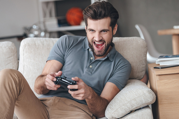 handsome man playing video game - 写真・画像