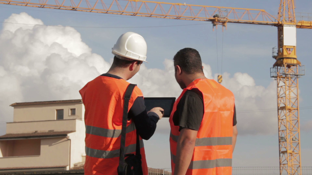 Construction people using electronic tablet on site - Footage, Video