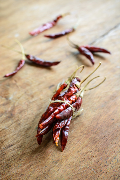 Dried chilli peppers on rustic wooden - Fotoğraf, Görsel