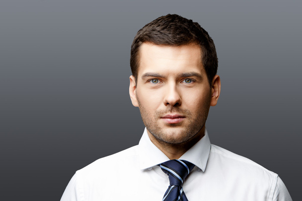 Handsome stylish businessman on grey background - Fotoğraf, Görsel