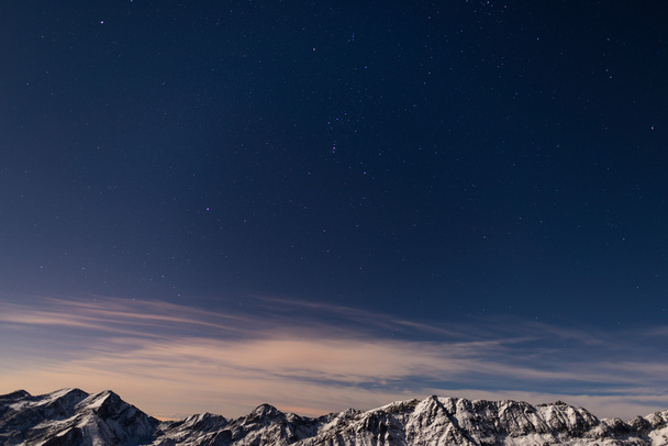 The starry sky above the Alps in winter, Orion Constellation - Фото, изображение